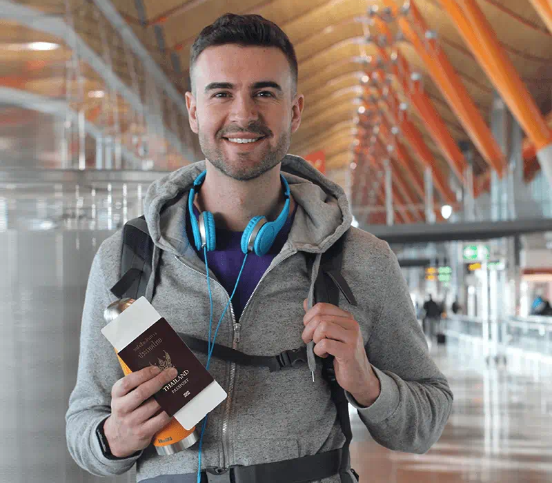 man in station holding passport
